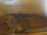 a close up of a wooden table with a clock on it