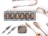 a tray of silverware and a tray of spoons on a table