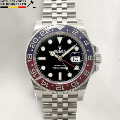 rolex watch with a black dial and red bezeled bezel