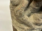 statue of a man holding a woman ' s head on a base