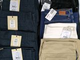 several pairs of men ' s pants are on display in a store