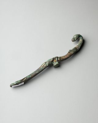 a close up of a metal object on a white surface