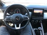 a picture of a person sitting in a car with their feet on the steering wheel
