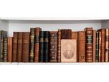 a shelf of old books on a white shelf