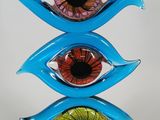 a close up of a sculpture of three different colored eyes