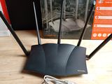 an image of a wireless router is sitting on a table next to a box