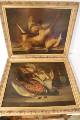 two paintings of birds on a table in a room
