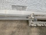 a piece of metal sitting on the side of a building