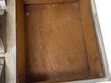 a metal box with a clock inside of it on a table