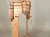 a wooden model of a castle on a stand