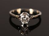 a close up of a diamond ring on a black surface