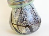 a glass vase with a blue and green design on it