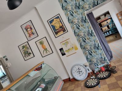 a picture of a room with a clock and pictures on the wall
