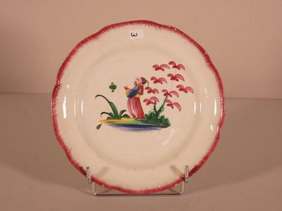a plate with a picture of a bird and flowers on it