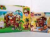 two boxes of lego super marios and a box of legos on a table