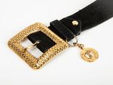the belt has a gold buckle and a black belt with a gold buckle