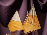 a small model of a sailboat on a wooden table