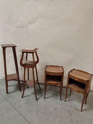 several pieces of furniture sitting on a cement floor next to a white wall