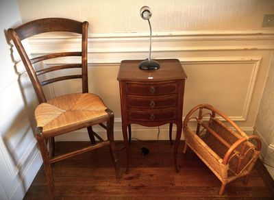 two chairs and a table with a lamp on top of it