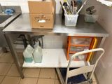 a metal table with a chair and a box on it