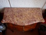 a small table with a marble top in a room