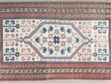 an old rug with a blue and red design on it