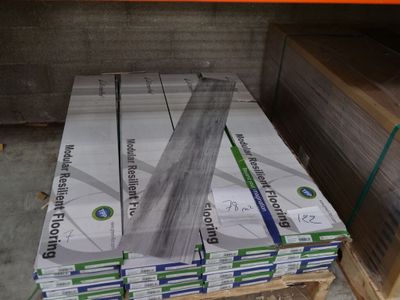 several stacks of cardboard are stacked on a pallet in a warehouse