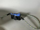 a small camera attached to a lanyard with a cord attached to it