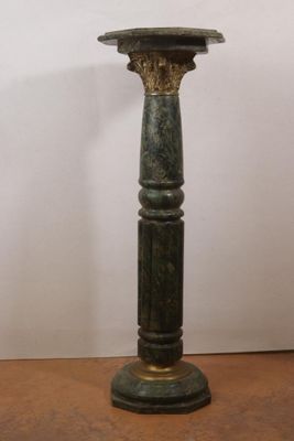 an image of a green candle holder on a wooden table