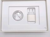 a white box with a charger and a cable in it