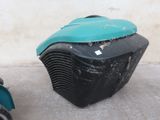 a small black and blue air conditioner next to a scooter