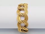a close up of a rope bracelet on a white surface