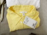 a yellow shirt and a white shirt with a tag on it