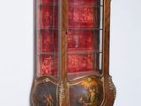 an antique display cabinet with a red velvet covering
