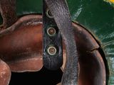 a close up of a helmet with a leather strap on it
