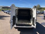 the back of a white van with its doors open in a parking lot