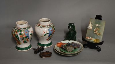 four vases sitting on a table next to a plate