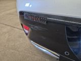 a close up of a car ' s rear bumper with a clock on it