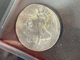 a silver coin with a picture of an angel on it