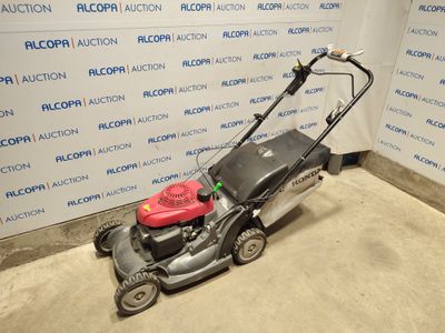 an image of a lawn mower parked in a room