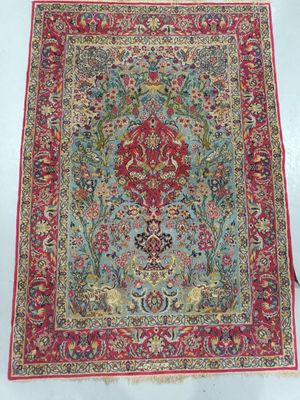 a red and blue rug with a floral design on it