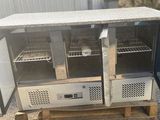 a small refrigerator that is sitting on top of a pallet