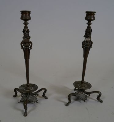 pair of antique brass candlesticks on cast iron bases