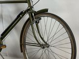 a bike that is parked against a white wall