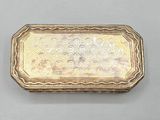 an antique silver cigarette case with a floral design on it