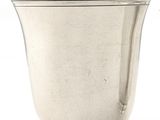 a silver cup that is sitting next to a silver cup