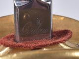 a bottle of perfume sitting on top of a gold plate