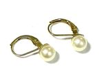 pair of pearl earrings on white background