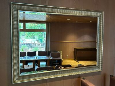 a mirror on the wall above a sink in a bathroom