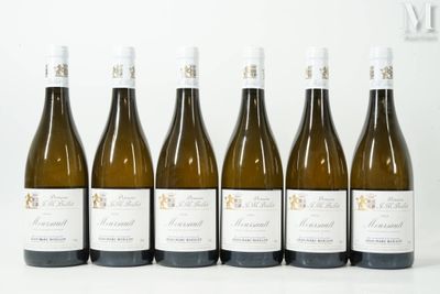 six bottles of wine are lined up in a row on a table